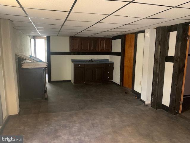 kitchen featuring sink, dark brown cabinetry, and a paneled ceiling