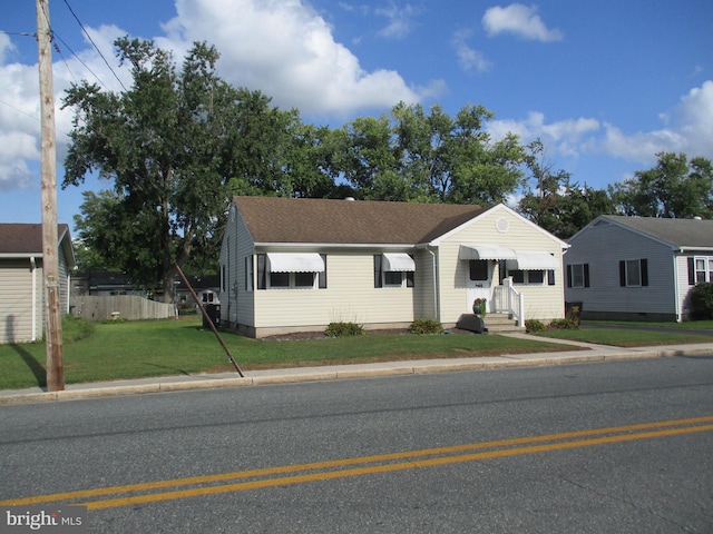 ranch-style home featuring a front yard