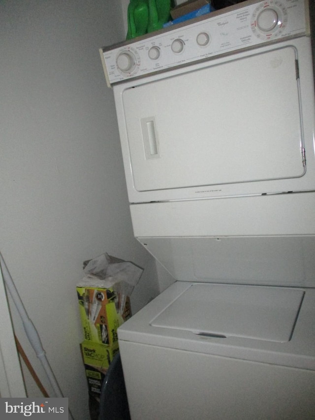 laundry room with stacked washing maching and dryer