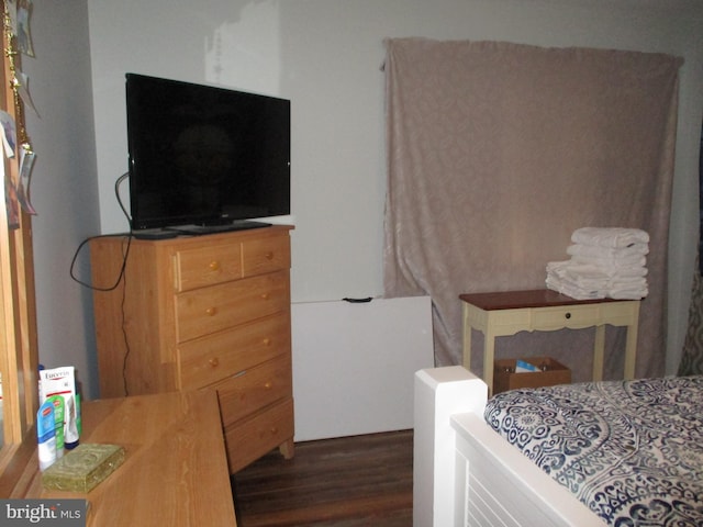 bedroom with dark wood-type flooring