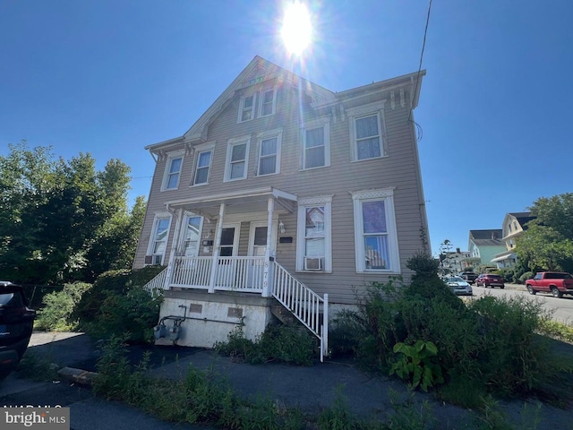 multi unit property featuring cooling unit and covered porch