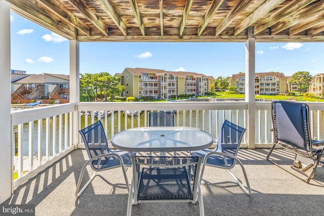 view of patio / terrace featuring outdoor dining space and a residential view