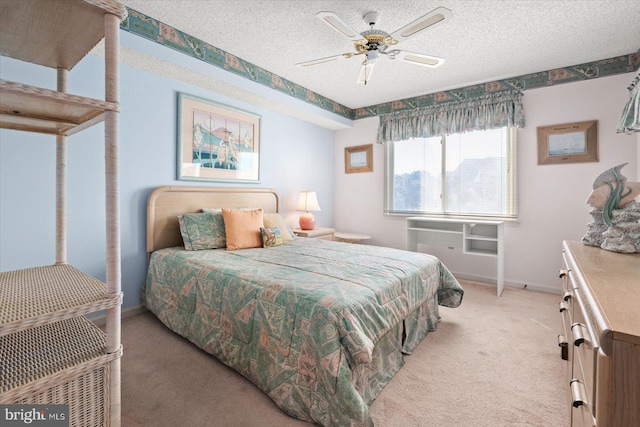 bedroom featuring a textured ceiling, carpet flooring, and ceiling fan