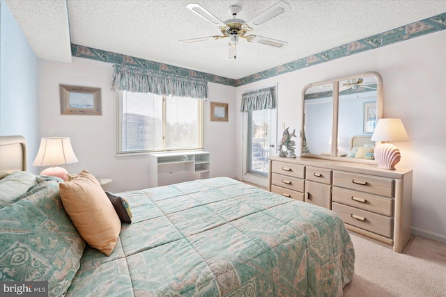 carpeted bedroom with ceiling fan and a textured ceiling