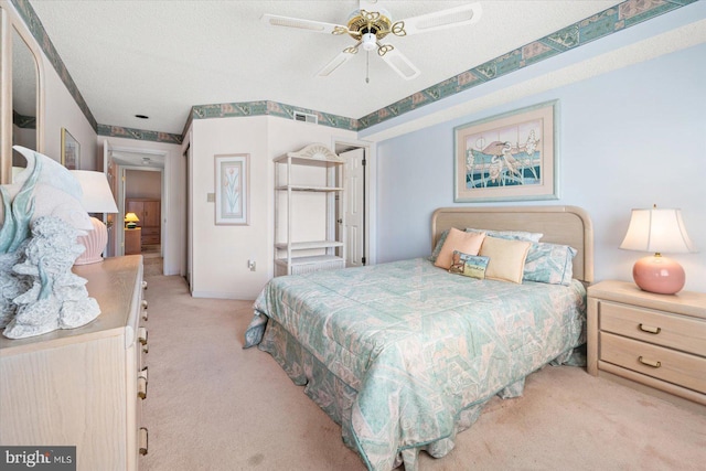 carpeted bedroom with a textured ceiling and ceiling fan