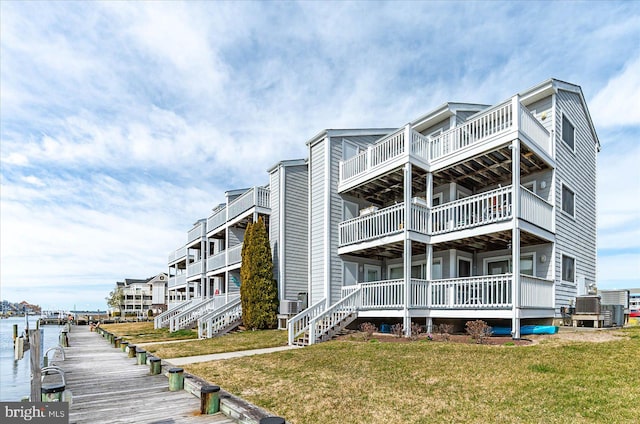 view of property with a water view and central AC unit