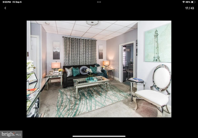 living room featuring a paneled ceiling