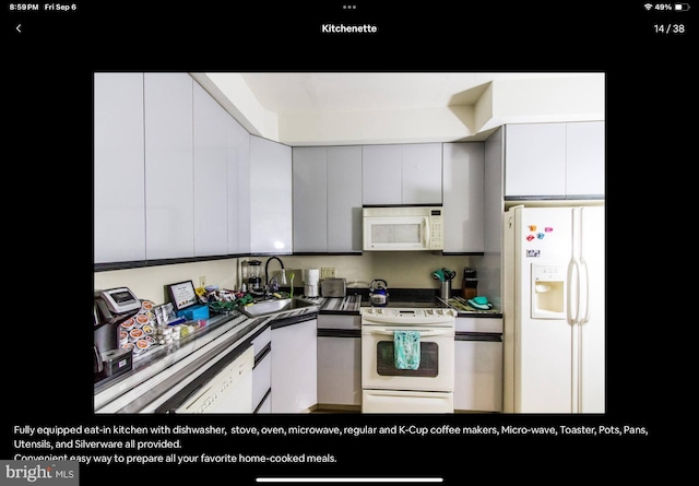 kitchen featuring gray cabinets, white appliances, and sink