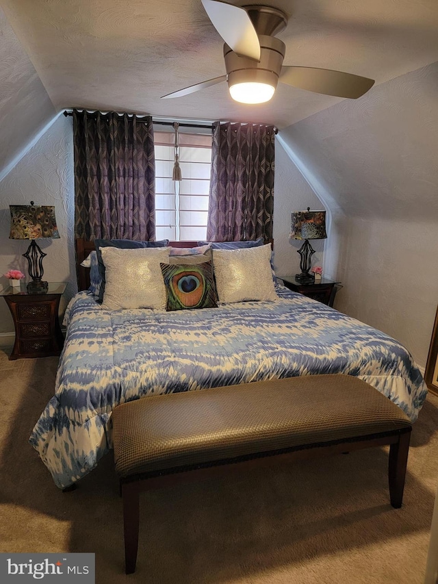 carpeted bedroom featuring a textured ceiling, ceiling fan, and vaulted ceiling