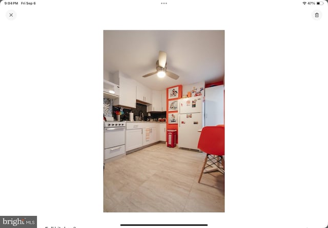 kitchen with white appliances, white cabinetry, sink, ceiling fan, and decorative backsplash