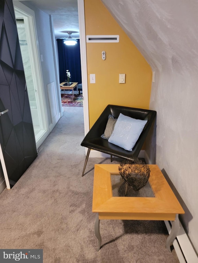 interior space with a textured ceiling, a baseboard radiator, and carpet floors