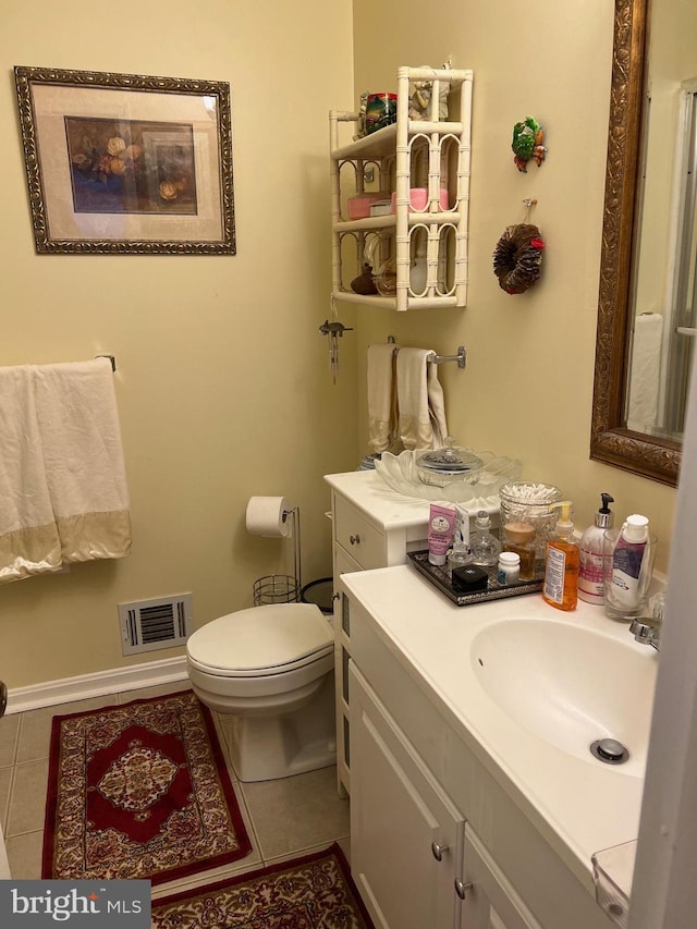 bathroom featuring vanity, toilet, and tile patterned floors