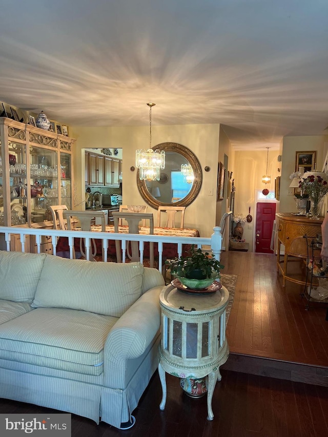 living room with a notable chandelier and hardwood / wood-style flooring