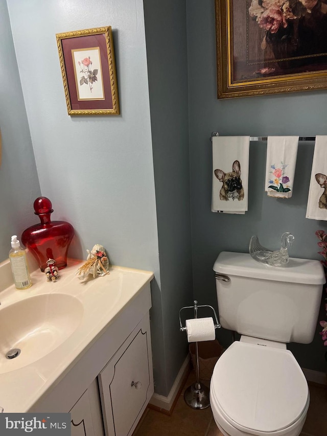 bathroom with tile patterned flooring, toilet, and vanity