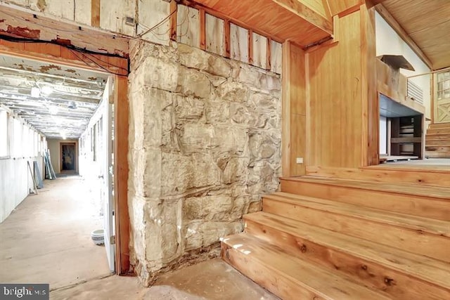 interior space featuring lofted ceiling and concrete flooring