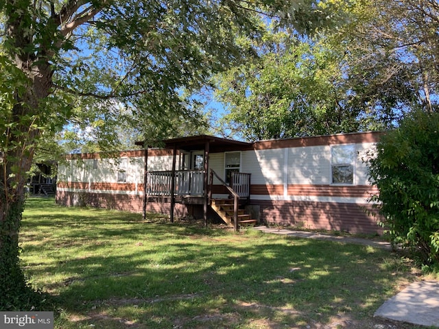 back of house with a yard and a deck