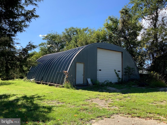 view of outbuilding featuring a yard