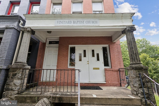 view of exterior entry with a porch