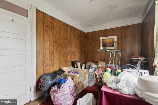 miscellaneous room featuring wooden walls