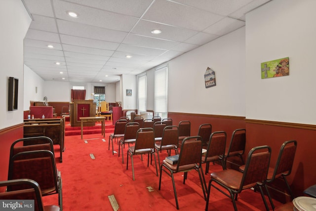 dining area with carpet floors and a drop ceiling