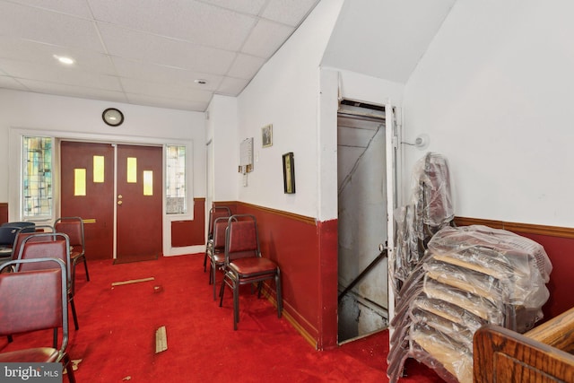 carpeted entrance foyer featuring a paneled ceiling