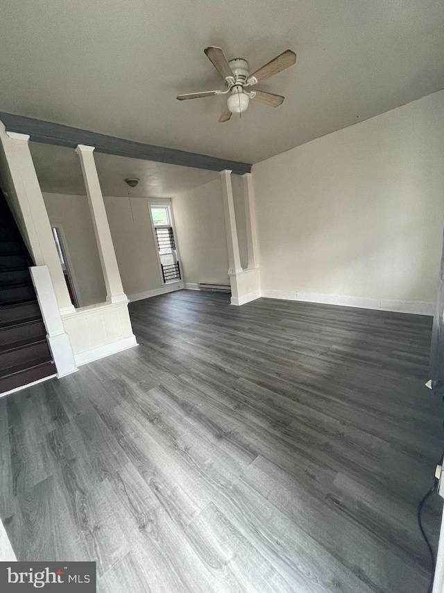 unfurnished living room with hardwood / wood-style flooring, baseboard heating, decorative columns, ceiling fan, and a textured ceiling