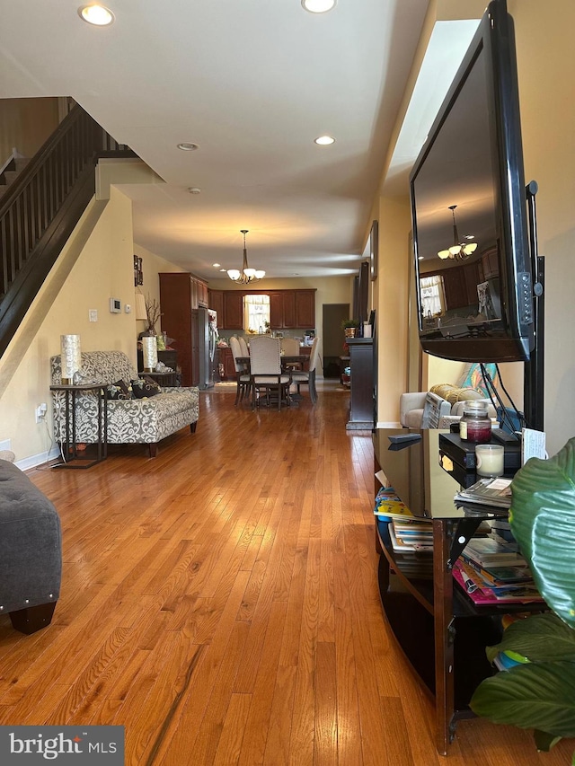 interior space featuring light hardwood / wood-style floors and an inviting chandelier