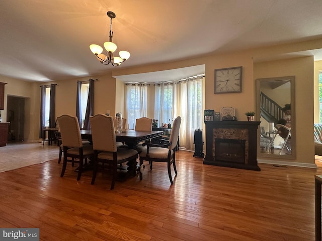 dining room with hardwood / wood-style flooring and a notable chandelier