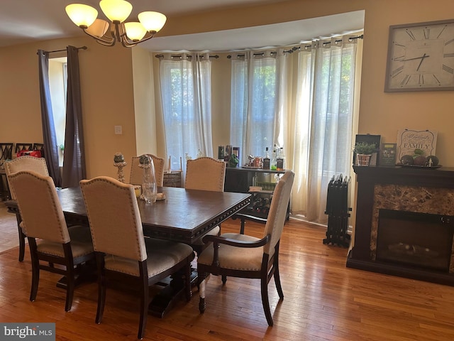 dining space with an inviting chandelier and hardwood / wood-style flooring