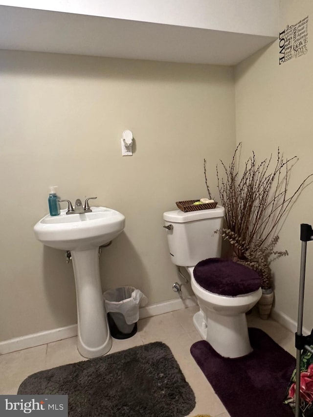 bathroom with tile patterned flooring and toilet