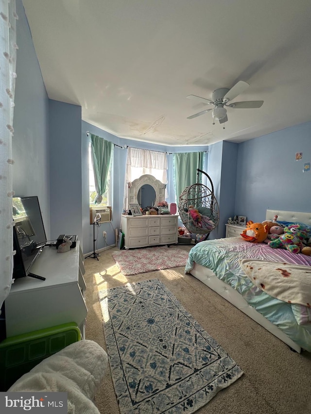 bedroom with ceiling fan, cooling unit, and carpet