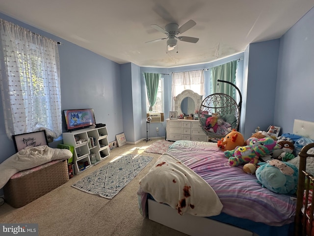 bedroom featuring cooling unit, ceiling fan, and carpet flooring