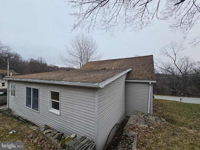 view of side of home featuring a shingled roof