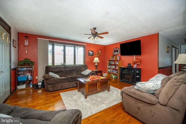 living room with ceiling fan and hardwood / wood-style flooring