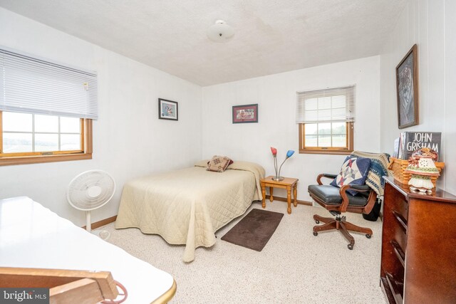 dining room with a textured ceiling, light carpet, and ceiling fan