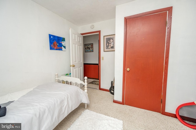 bedroom with a textured ceiling and carpet flooring