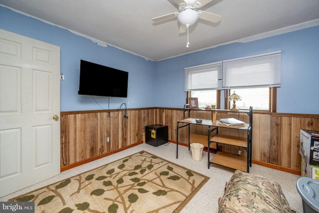 interior space with wood walls and ceiling fan