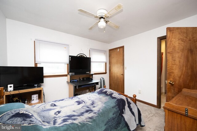 carpeted bedroom with baseboards and ceiling fan
