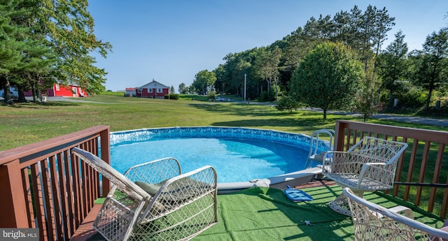 view of pool with a yard