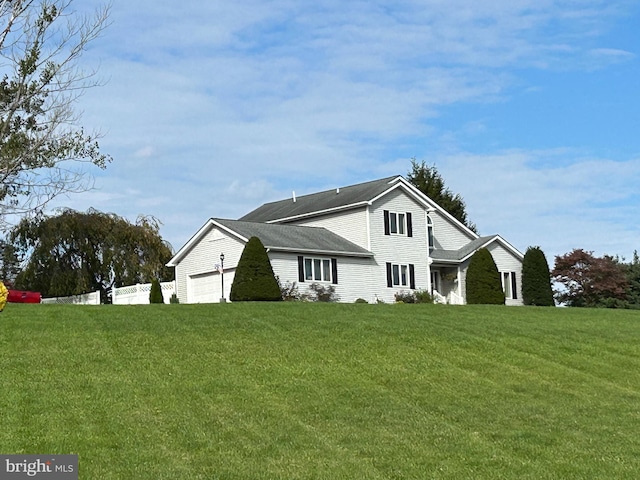 view of home's exterior featuring a garage and a lawn