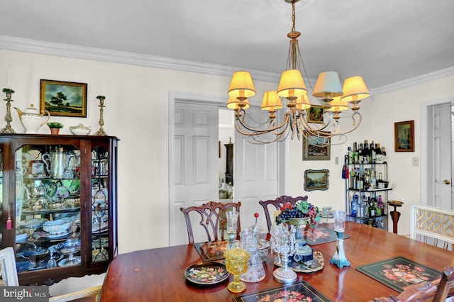 dining space with a notable chandelier and ornamental molding