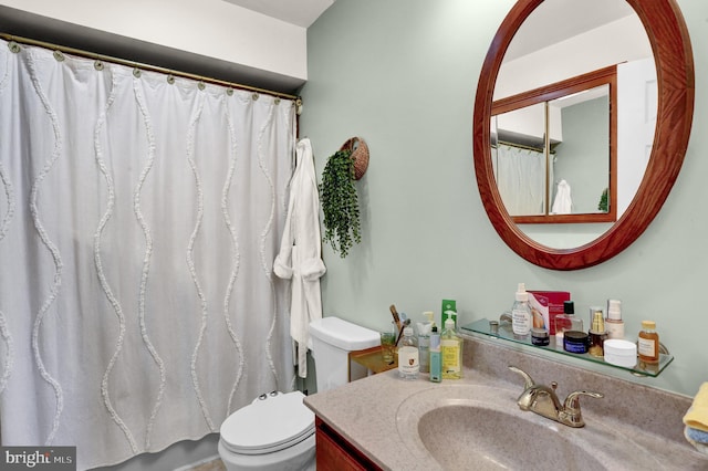 bathroom featuring vanity, toilet, and a shower with shower curtain