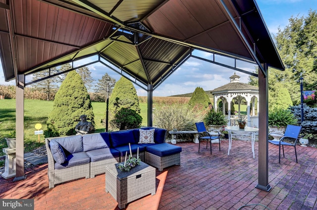 view of patio with an outdoor living space and a gazebo