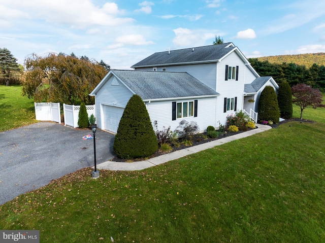 exterior space featuring a lawn and a garage