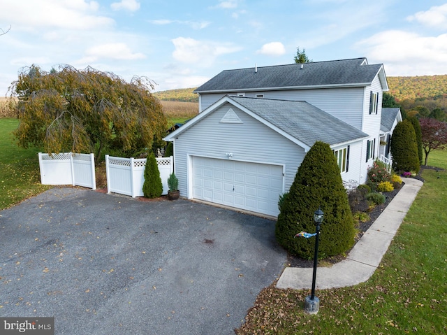 view of home's exterior featuring a garage and a yard