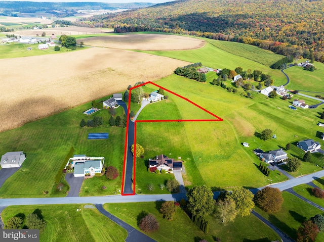 birds eye view of property with a rural view