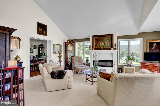 carpeted living room featuring high vaulted ceiling and a wealth of natural light