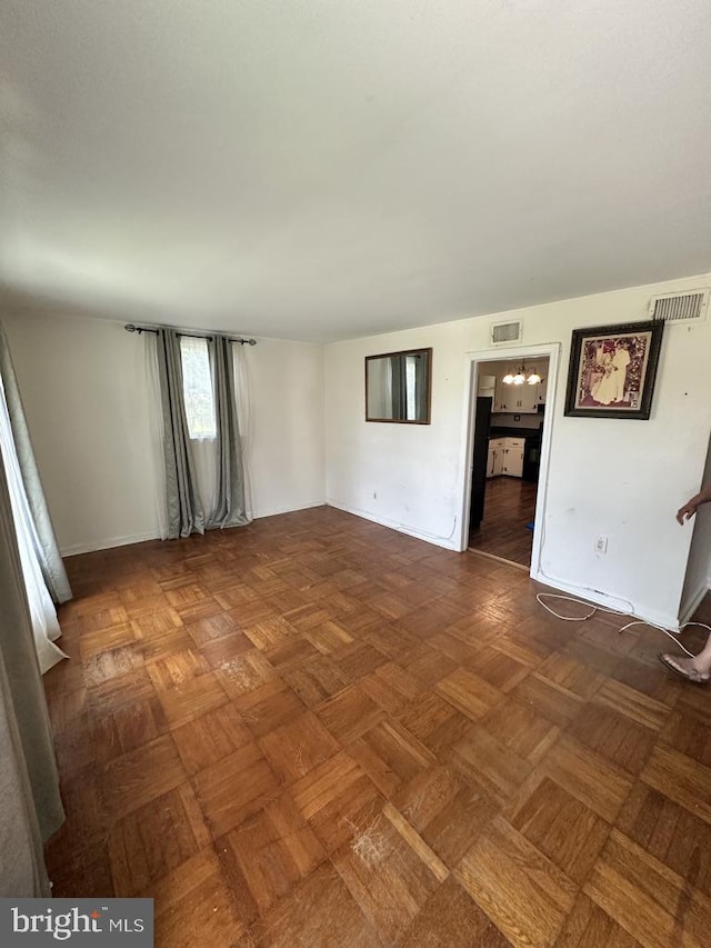 unfurnished living room featuring dark parquet floors