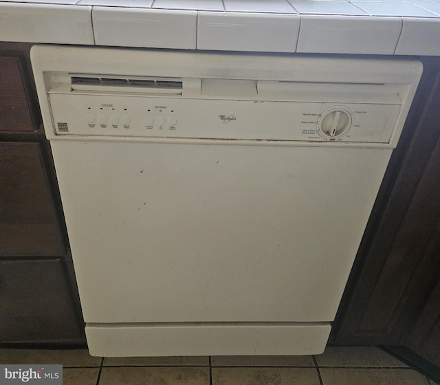 interior details featuring white dishwasher and tile patterned floors