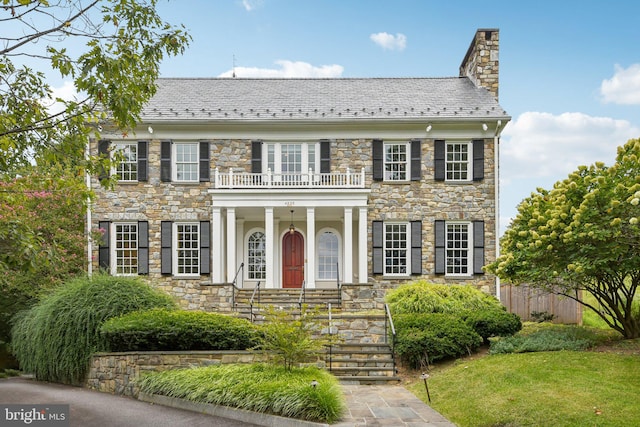 colonial inspired home featuring a balcony